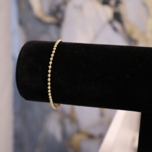 Manilla de bolitas sólida 14k.